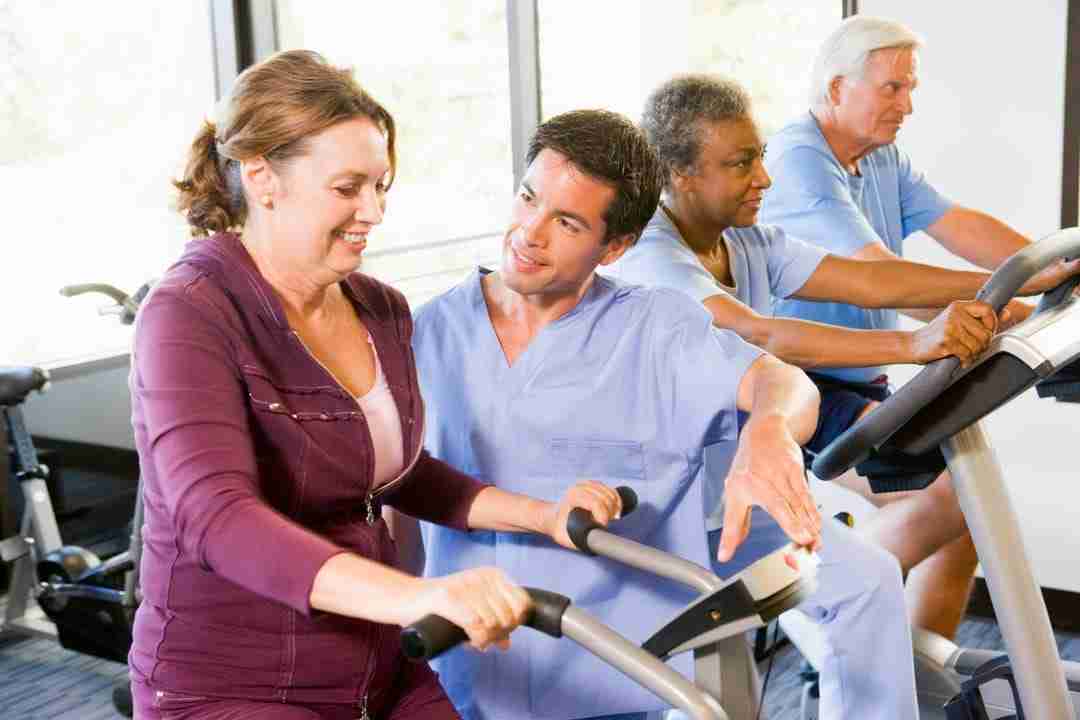 Physical therapist assists patient with physical activity